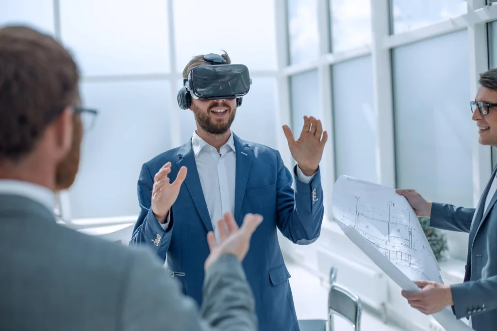 Architect presenting virtual building model to colleagues using VR headset