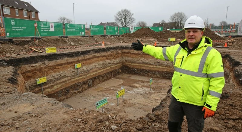 Geotechnical engineer inspecting soil layers at construction site.